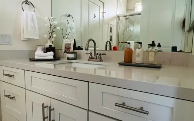 Marble bathroom vanity with orchids and toiletries